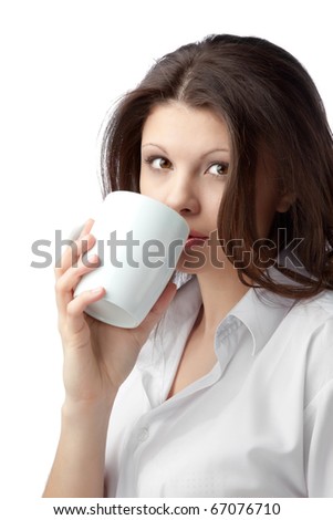 A beautiful young female woman enjoying a cup of tea/coffee
