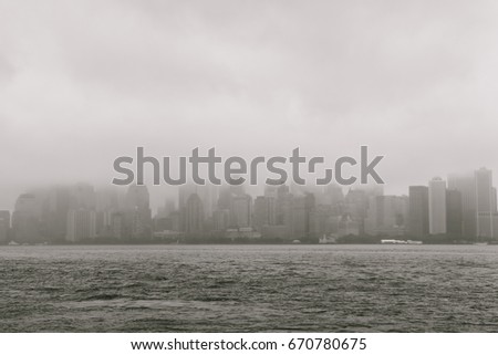 Buildings in Lower Manhattan (New York) on a very foggy day, viewed from Ellis Island