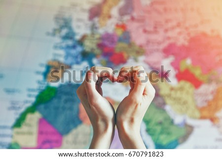 hand in heart shape with love on world map background Royalty-Free Stock Photo #670791823