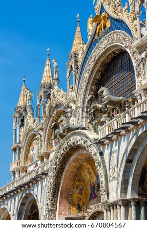 St Mark`s Basilica (San Marco), Venice, Italy. Saint Mark`s Basilica close-up on a sunny day. Luxuru decoration of St Mark`s exterior in summer. Ornate Renaissance facade of St Mark`s cathedral.