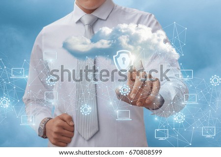 Businessman puts a protection on a data cloud in the sky.