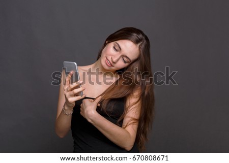 Joyful young woman taking selfie by her smart phone. Attractive girl making picture of herself, instagram, modern lifestyle concept