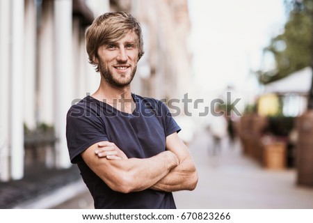 Handsome smiling young man portrait. Cheerful men looking at camera