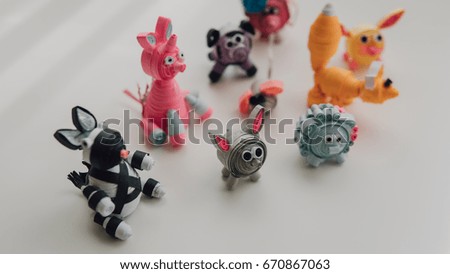 Cartoon paper toys made by own hands close-up. Toys made by the technology of quilling. Children's crafts made of paper