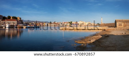 Panoramic view of Old harbor of Chania with the lighthouse and fortification at sunrise, Crete, Greece