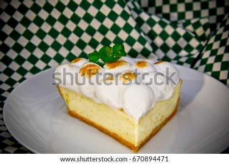 Meringue lemon tart slice in a plate 