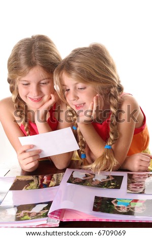 children looking at photos together vertical