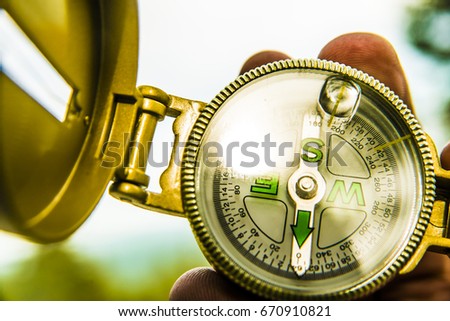 close up photo image. Compass in hand on nature background. business concept of direction 