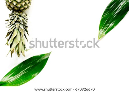 Pineapple and leaves on white background top view copyspace