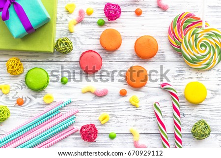 Birthday concept with wrapped gift and sweets on grey background top view