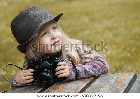 little beautiful girl with a photo camera