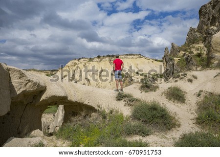 Famous Europe destination Cappadocia in central Turkey. Man observes Cappadocia nature and views and unusual rock formations