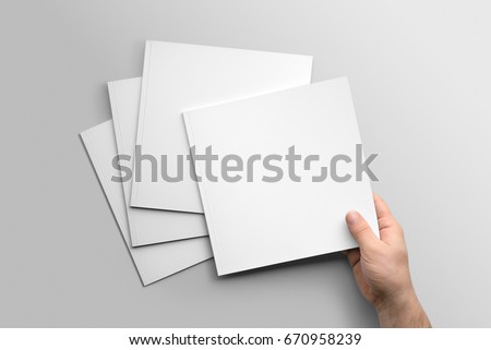 Blank square photorealistic brochure mockup on light grey background.  Royalty-Free Stock Photo #670958239