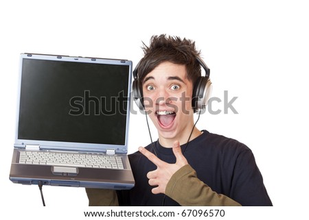 Male Teenager with earphones and laptop points enthusiastic at computer display. Isolated on white background.