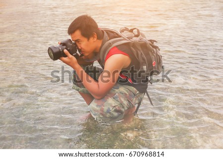 Asian men traveling adventure are taking photo at Nai Yang Beach Phuket Thailand