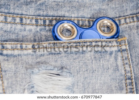 Blue spinner on jeans background