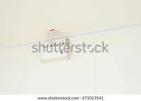 Emergency light on white wall industry background.Safety first concept.