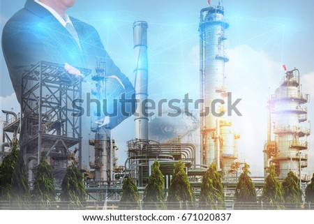 Double exposure of Businessman arms crossed and stand up,digital light networking world map, Electric Generating, fuel oil Factory and Energy Industry plant as business, industrial and energy concept.