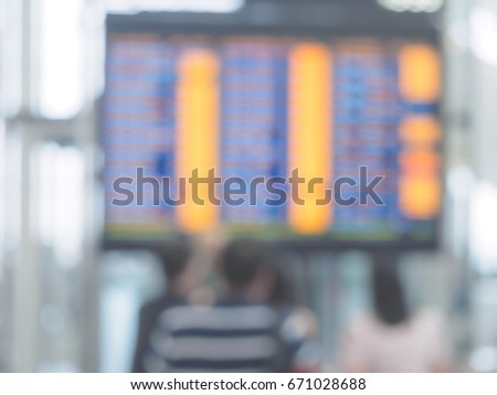Blur series, Abstract blurred photo of airport boarding panel with many delayed messages, bokeh background.