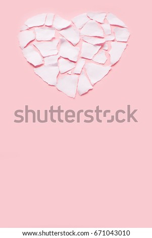 Broken heart breakup concept separation and divorce icon. White crumpled paper shaped as a torn love