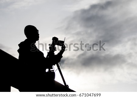 Photographer silhouette shooting outdoors