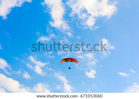 man active extreme sport pilot flying in sky with paramotor engine to freedom from trouble barrier.