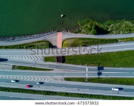 Cars driving along the coastline. Aerial view