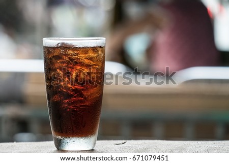 Cola in glass background blur Royalty-Free Stock Photo #671079451