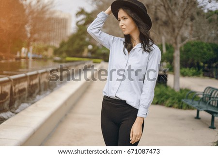 young model brunette on the street in a hat