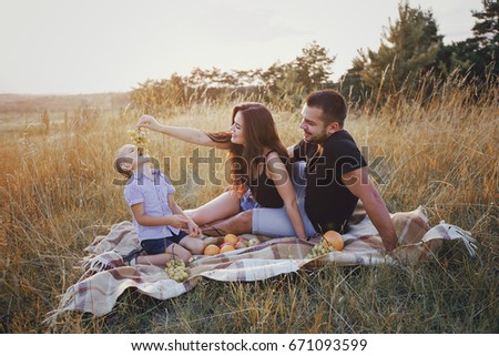 young family with a child have fun outdoors playing games love each other