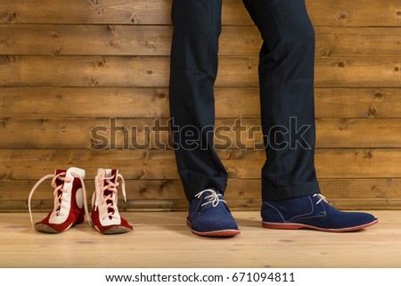 Shoes for wrestling in the corner next to the athlete in trousers