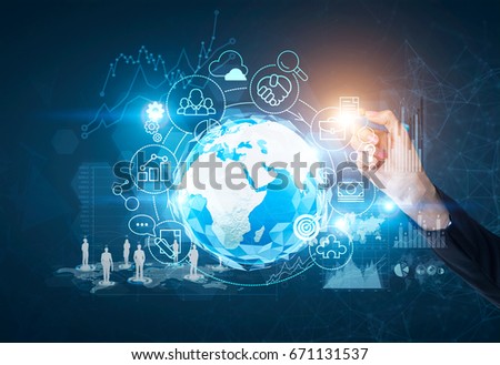 Close up of a hand of an unrecognizable person drawing business icons in a holographic surrounding. Planet in the center. Toned image mock up double exposure. Elements of this image furnished by NASA