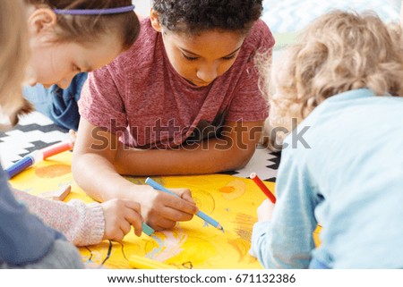 Young children having fun during art lesson in school