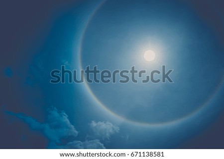 Beautiful abstract Sun halo and white cloud on dramatic blue sky in the summer morning