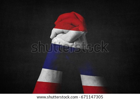 Man clasped hands patterned with the THAILAND flag.Black background