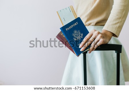 Closeup of girl holding passports and boarding pass Royalty-Free Stock Photo #671153608