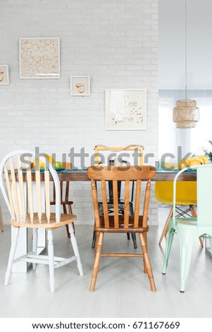 Dining space with upcycled wooden chairs and table in stylish fancy loft