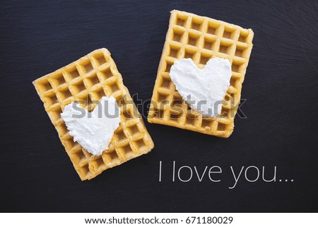 Delicious Belgian waffles with cream on a black background-inscription I love you