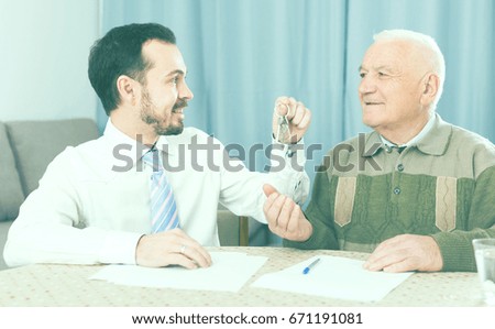 Retired and young man signed contract of rent apartments and hand over keys