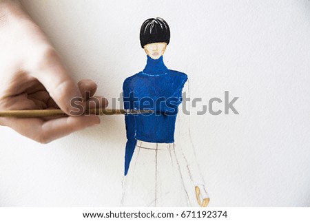 photo of girl drawing fashion women clothes