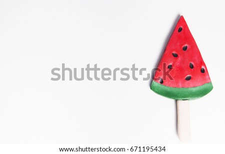 photo of watermelon shaped ice cream pop on white background