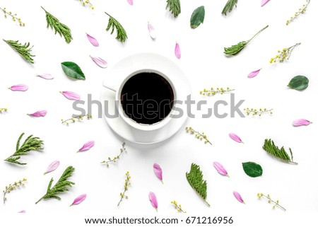 Floral pattern with coffee on white table background top view mo