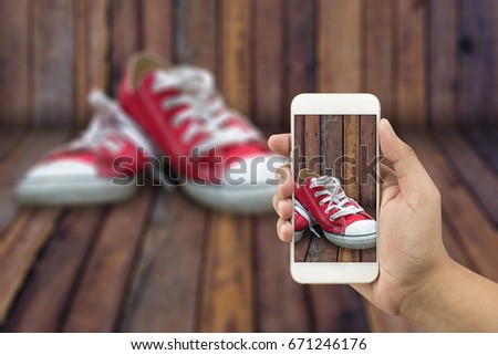 Red shoes sold through the sale of online. Red shoes are on wooden floors. Photography with high definition mobile To get a clear picture of the red shoes are sharp on sale through online channels.