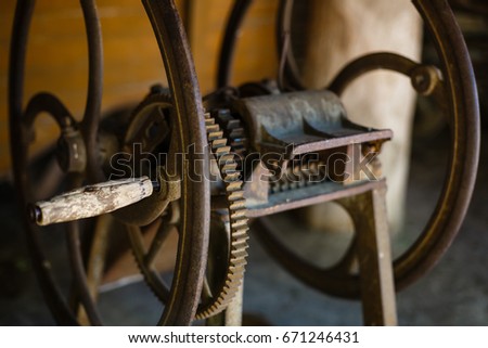 very old spinning wheel and a spindle