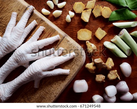The picture of ingredient for chicken feet curry soup on  wooden table.