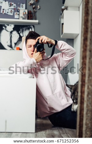 Photographer with a camera takes a picture of himself