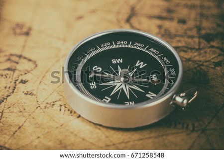 Vintage compass on retro map for explorer concept