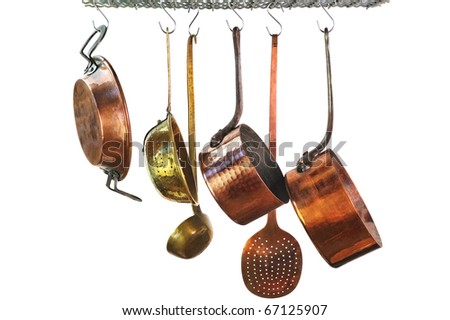 saucepans hanging from a rack in a traditional style kitchen Royalty-Free Stock Photo #67125907