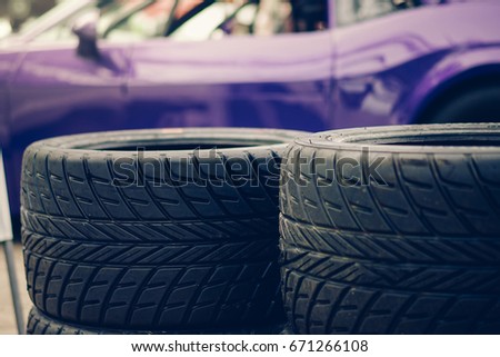Closeup Tire overlap competition trophy and violet racing car 