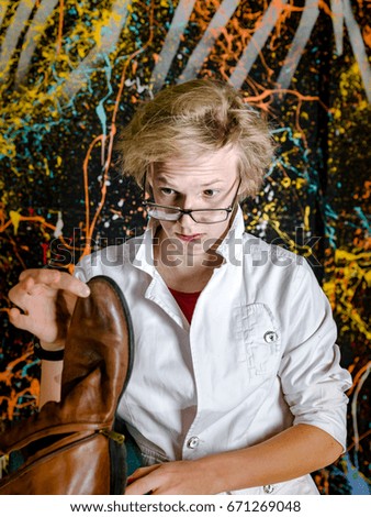 Funny teenage boy posing like a crazy professor or student, expressive person